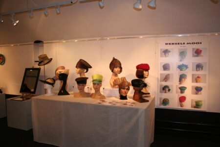 Display heads for presenting hats by Deksels Mooi
