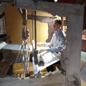 mannequin weaves linen cloth on loom