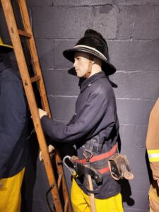 Firefighter climbs ladder | lifelike display mannequin in uniform