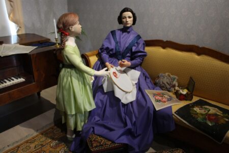 Display mannequin broidering scene in Biedermeier interior at Marela museum
