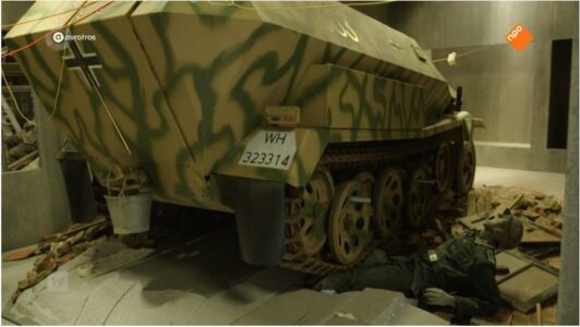 Mannequin of a German WW2 soldier screams because he is trapped under an armored vehicle.