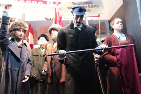 Revolutionary parade of display mannequins in realistic poses with lifelike silicone heads and hands.