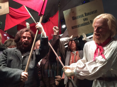 Revolutionary parade of display mannequins in realistic poses with lifelike silicone heads and hands.