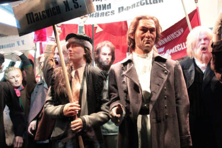Revolutionary parade of display mannequins in realistic poses with lifelike silicone heads and hands.